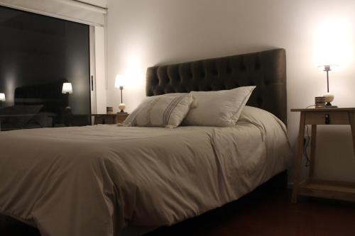 een slaapkamer met een groot bed met witte kussens bij Magnolia Suites Apart 1 in Buenos Aires