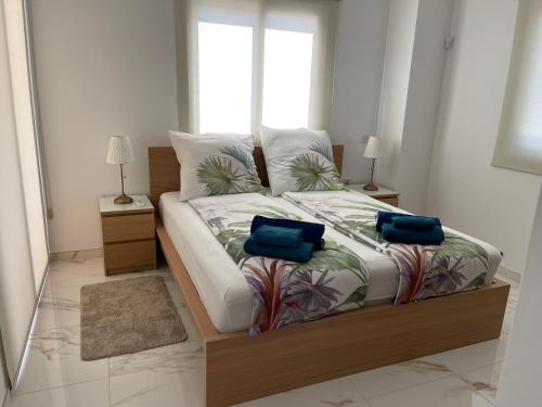 sypialnia z łóżkiem z 2 niebieskimi poduszkami w obiekcie VILLA CORAL VIEW w mieście Peja