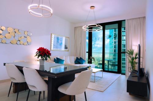 a dining room and living room with a table and chairs at Elegant Apartment with Direct access to Dubai Mall in Dubai