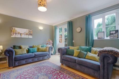 a living room with two couches and a rug at Charming 4 Bedroom House in Prime Location - Close to City Centre - Free Parking, Smart TVs and Landscaped Garden by Yoko Property in Milton Keynes