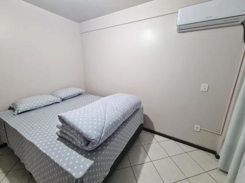 a bedroom with a bed with two pillows on it at Apartamento com mobília nova 201! in Francisco Beltrão