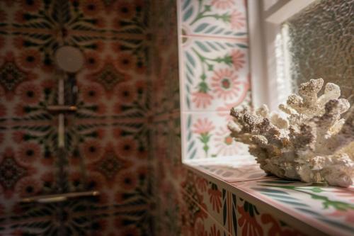 a white object sitting on a shelf in a room with a window at 2 Elgin House in Seaview