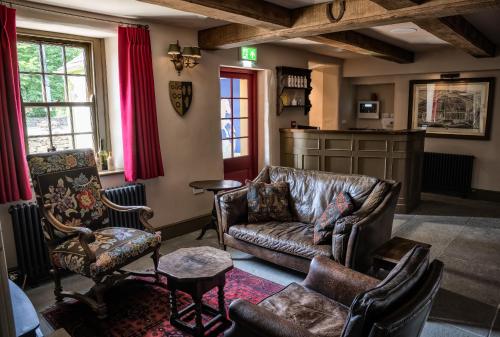 a living room with a leather couch and chairs at George and Dragon Clifton in Penrith