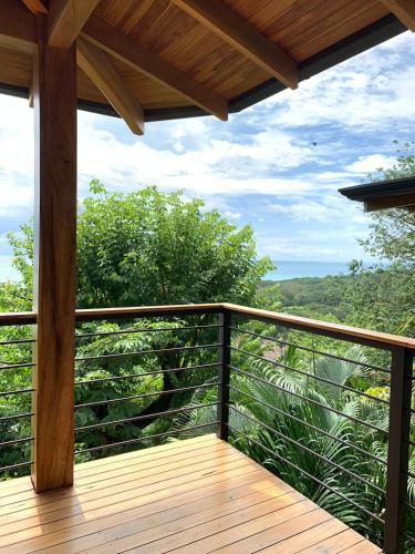 a wooden balcony with a view of the forest at Vista del Alma Boutique - Adult Only in Santa Teresa Beach