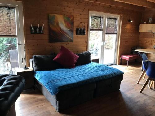 a living room with a couch in a wooden room at Obere-Seeterrasse in Rieden