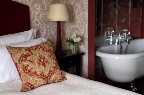 a bed with a pillow and a sink in a room at George and Dragon Clifton in Penrith