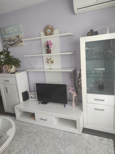 a white entertainment center with a television on it at Apartman Ana in Čapljina