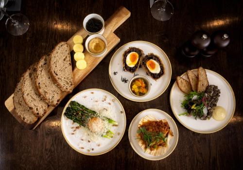 a table with plates of food and bread on it at George and Dragon Clifton in Penrith