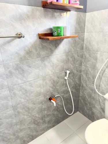 a bathroom with a shower with a toilet at Sally's home-near JNIA airport in Dar es Salaam
