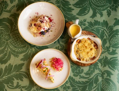 two plates of food and a cup of coffee on a table at George and Dragon Clifton in Penrith