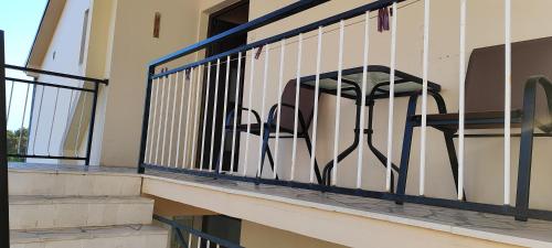 a black chair sitting on a balcony at Sea and Sunshine in Tivat