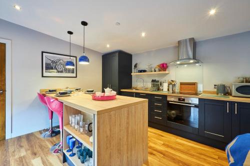 a kitchen with a island in the middle of a room at Host & Stay - Ocean Blue Lodge in Alnwick