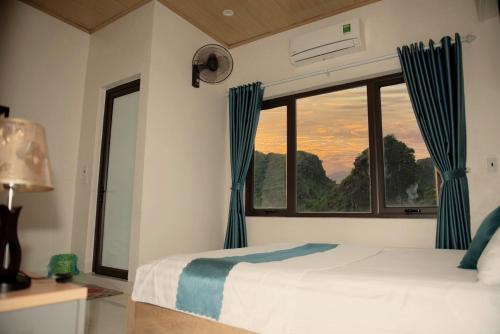 a bedroom with a bed and a large window at Cherry homestay in Ninh Binh