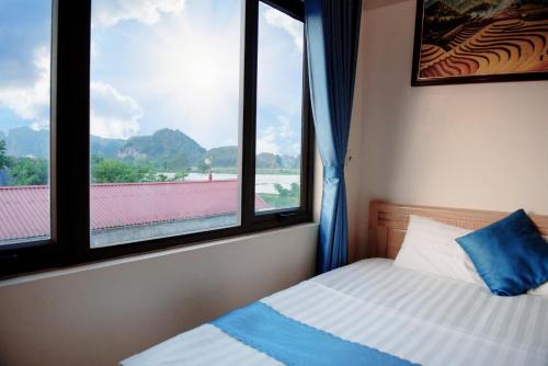 a bedroom with a bed and a window with a view at Cherry homestay in Ninh Binh