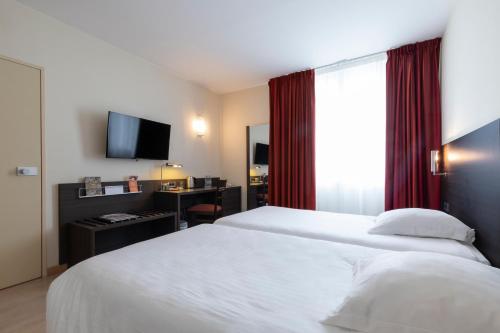 Un ou plusieurs lits dans un hébergement de l'établissement Hôtel Oceania Brest