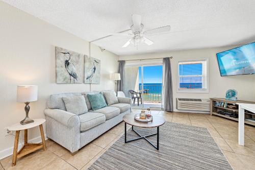 a living room with a couch and a table at Emerald Skye 54 in Orange Beach