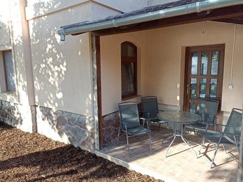 a patio with a table and chairs outside of a house at Villa Fonyód in Fonyód