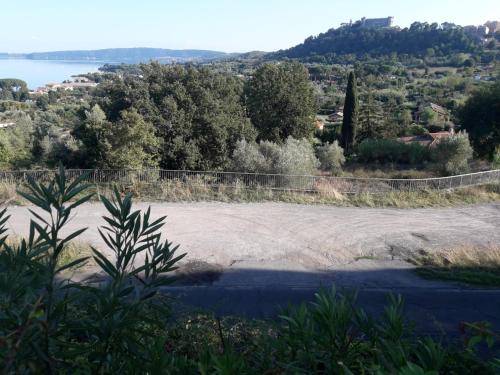 a large dirt field next to a body of water at La Cerasa - Country house il lago fuori in Bracciano