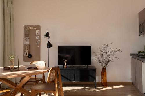 a living room with a table and a flat screen tv at Bob W Ponte Vecchio in Florence