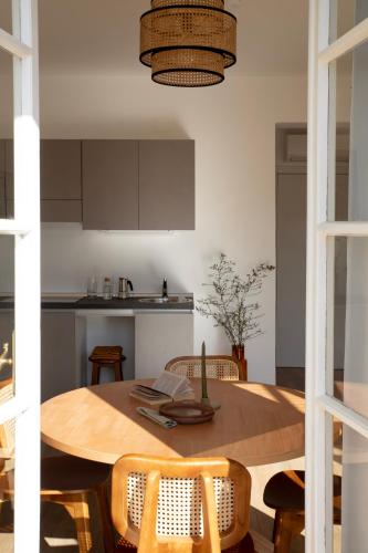 a kitchen with a wooden table with chairs and a dining room at Bob W Ponte Vecchio in Florence