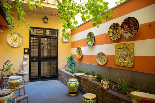 a room with plates on the wall of a building at Bob W Ponte Vecchio in Florence