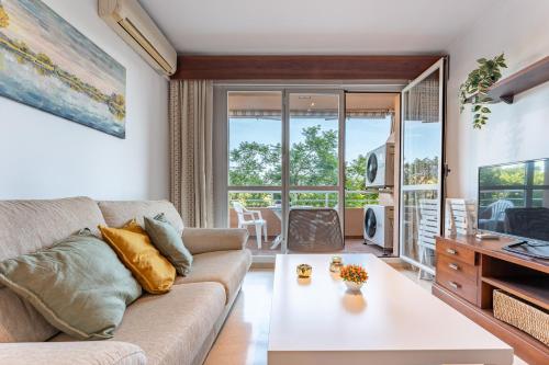 a living room with a couch and a table at MalagaSuite Dreamy Village in Arroyo de la Miel