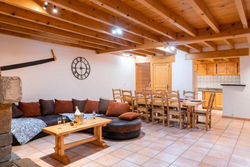 a living room with a couch and a table at Gîte La Grange logement de qualité in Cauterets