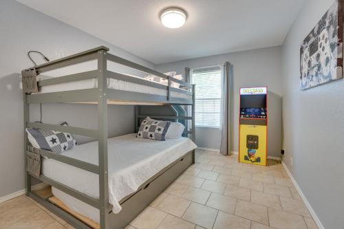 a bedroom with a bunk bed and a play floor at Sunny Universal City Home about 18 Mi to San Antonio! in San Antonio