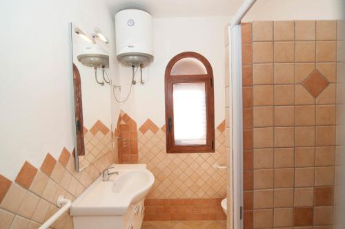 a bathroom with a sink and a mirror at Appartamenti Sant'Anna in Budoni