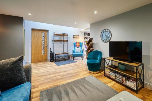 a living room with a couch and a flat screen tv at Host & Stay - Narrowgate Apartments in Alnwick
