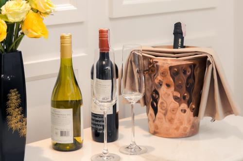 two bottles of wine and two glasses on a counter at CHINO@NIMMAN Luxury Boutique Hotel in Chiang Mai