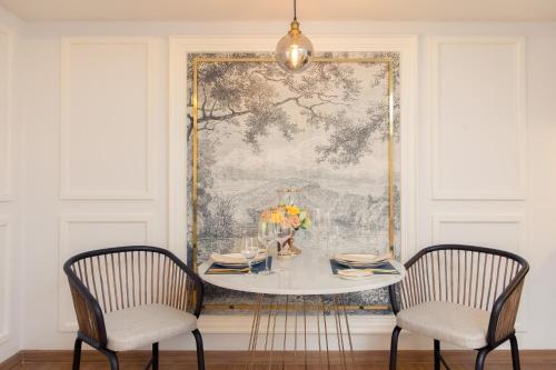 a dining room with a table and two chairs at CHINO@NIMMAN Luxury Boutique Hotel in Chiang Mai