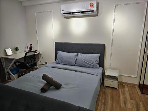 a bedroom with a bed with a stuffed animal on it at Arte Cheras The Premium Suites by iLuxHome in Kuala Lumpur