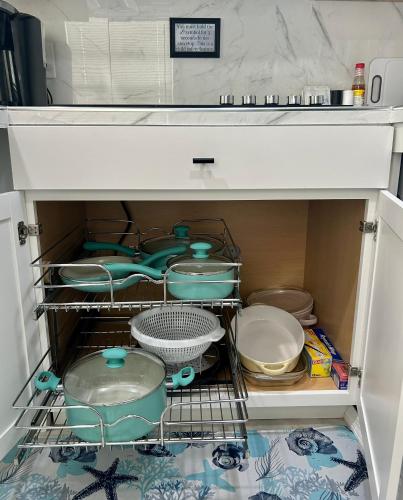 a drawer filled with dishes and bowls in a refrigerator at Cocoa, Beach house in Cocoa
