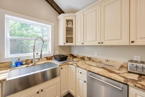 a kitchen with white cabinets and a sink and a window at Beautiful Franklin Home with Bunkhouse and Hot Tub! in Franklin