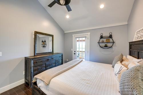 a bedroom with a large bed and a mirror at Beautiful Franklin Home with Bunkhouse and Hot Tub! in Franklin
