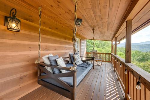 a porch swing in a log cabin with a view at Beautiful Franklin Home with Bunkhouse and Hot Tub! in Franklin