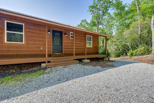 a cabin in the woods with a front porch at Beautiful Franklin Home with Bunkhouse and Hot Tub! in Franklin