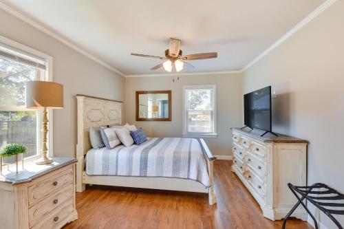 a bedroom with a bed and a flat screen tv at Greenville Vacation Rental - 3 Mi to Downtown! in Greenville