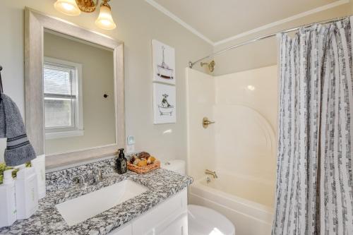 a bathroom with a sink and a toilet and a mirror at Greenville Vacation Rental - 3 Mi to Downtown! in Greenville