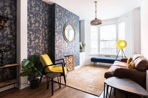a living room with a couch and a chair at Luxurious 4-Bed Townhouse in the Heart of Belfast in Belfast