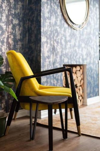 a yellow chair in a room with a mirror at Luxurious 4-Bed Townhouse in the Heart of Belfast in Belfast