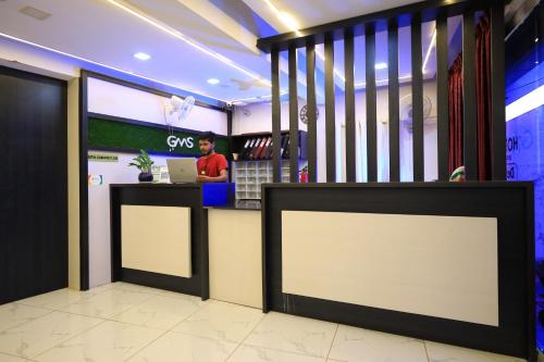 a cvs store with a counter and a person in the background at Hotel Gamas Inn in Chacka