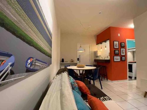 a living room with a couch and a table at Mais espaço com estilo e vista para o mar in João Pessoa