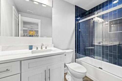 a bathroom with a toilet and a sink and a shower at Scissortail at Treetop in Santa Rosa Beach