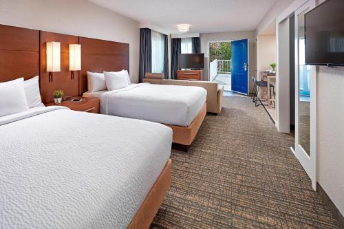 a hotel room with two beds and a kitchen at Residence Inn Los Angeles LAX/Manhattan Beach in Manhattan Beach
