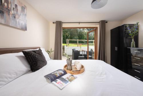 a bedroom with a white bed with a basket on it at Robins Rest, Nr Perranporth in Perranporth