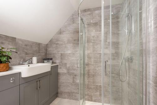 a bathroom with a shower and a sink at Robins Rest, Nr Perranporth in Perranporth