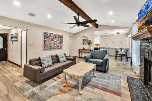 a living room with a couch and a fireplace at New Cozy Retreat Located 15 minutes to Waco in Hewitt