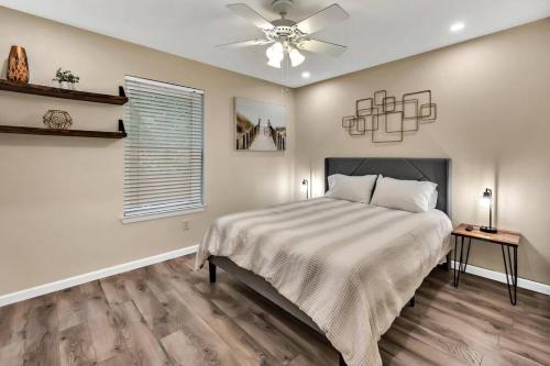 - une chambre avec un lit et un ventilateur de plafond dans l'établissement New Cozy Retreat Located 15 minutes to Waco, à Hewitt